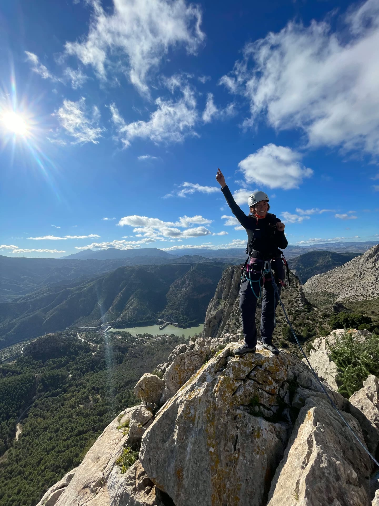 Celebrating on a rocky summit under a blue sky