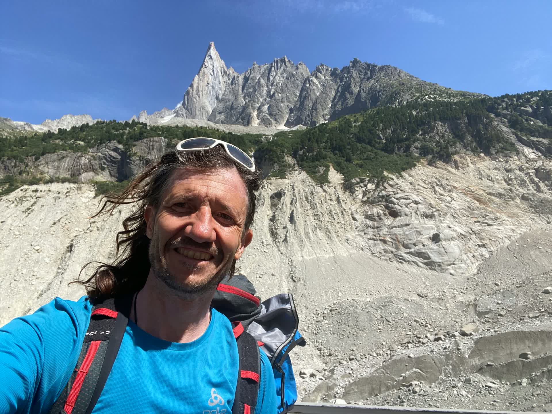 In front of a pointed granite spire